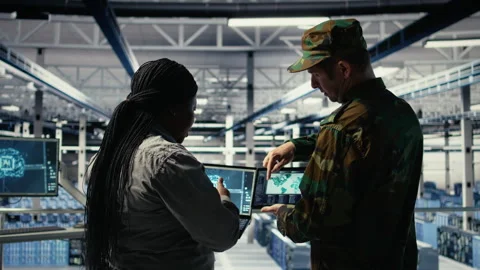 Military commander and female programmer in data center tracking coordinates Stock-Footage 314685162