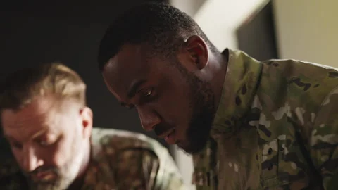 Military commanders planning intervention, discussing mission details over maps Stock Footage 333308243
