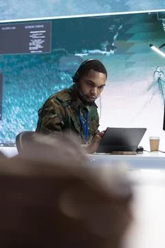 Military crew in a high tech control center working with real time data Stock Photos