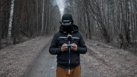 Military drone operator at war, preparing for flight, filming in forest Stock Photos