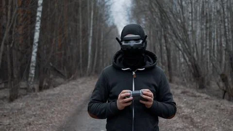 Military drone operator at war, preparing for flight, filming in forest Stock Photos