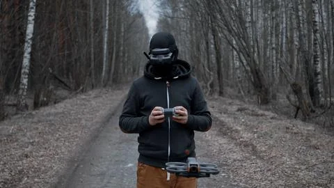 Military drone operator at war, preparing for flight, filming in forest Stock Photos