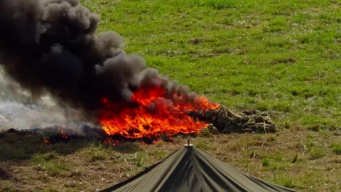 Military equipment on fire during attack on the enemy with soldiers Stock Footage 337204344