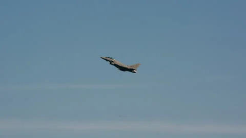 Military fighter jet flying level with engine exhaust trail Stock Footage 346220264