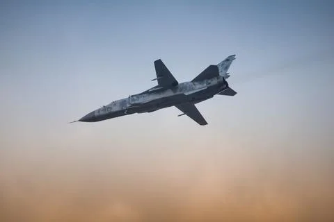 Military fighter plane with variable sweep wing on sky background. Fotos de archivo