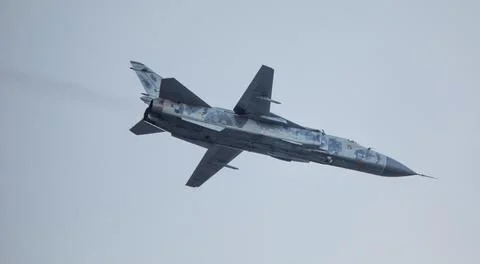 Military fighter plane with variable sweep wing on sky background. 스톡 사진