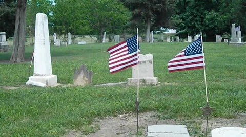 Military Flags Flowing at a Cemetery Stock Footage 24089259
