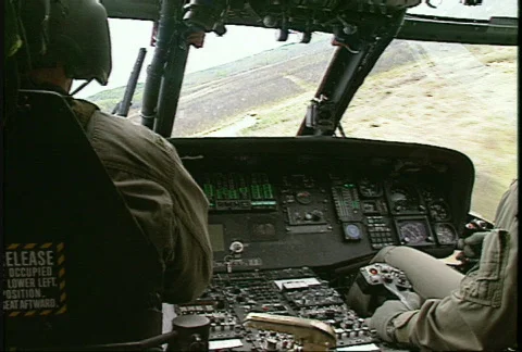 Military, flying, interior cockpit, UH60 Blackhawk helicopter, low level Stock Footage