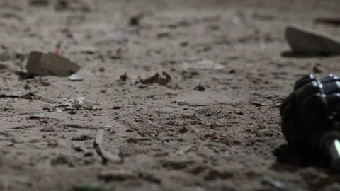 Military grenade stops on the floor without a safety lever. A hand grenade Stock Footage 132437042