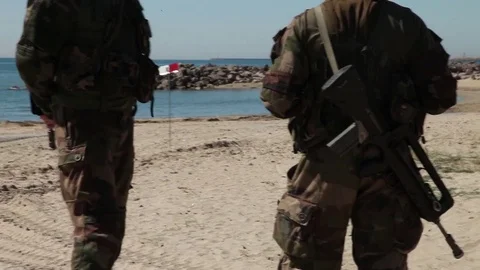 Military guards on beech Видео 76293370