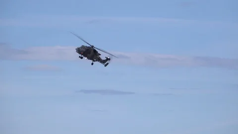 Military helicopter flying overhead and doing manoeuvres UK 4K Stock Footage