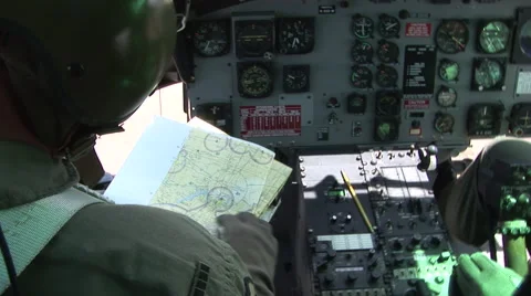 Military helicopter pilots navigate while flying Stock Footage 41057851