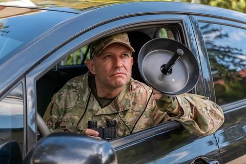Military intelligence operative eavesdropping with directional microphone f.. 库存照片