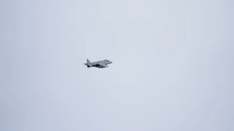 Military Jet Hovering in Overcast Sky Stock Footage 330039866