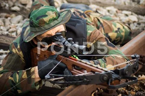 Military man aiming with crossbow Stock Photos