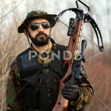 Military man with crossbow Stock Photos
