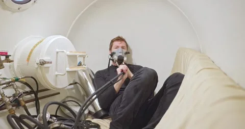 Military man in hyperbaric chamber using BIBS mask Stock Footage 275341451