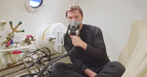 Military man in hyperbaric chamber using BIBS mask Stock Footage 275341468