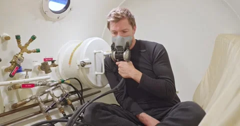Military man in hyperbaric chamber using BIBS mask Stock Footage 275341560