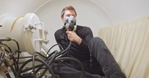 Military man in hyperbaric chamber using BIBS mask Stock Footage 275341588
