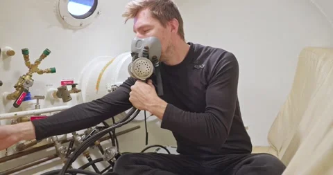 Military man in hyperbaric chamber using BIBS mask Stock Footage 275341591