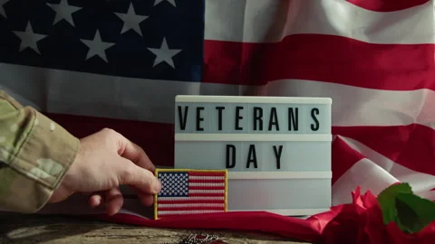 Military man leaving a USA patch flag to celebrate Veterans Day Stock Footage 253638232