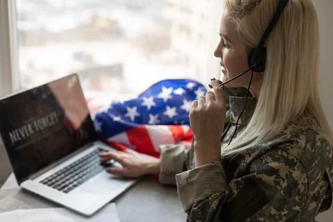 Military man using laptop with veterans day screen Stock Photos