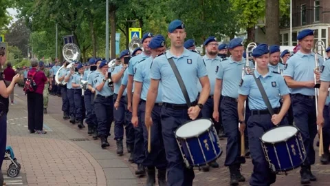 Military marching band playing drums in street during Airborne parade in Видео 346006512