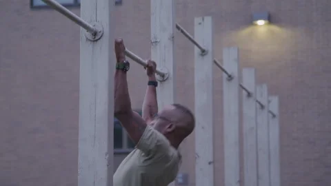 Military Member Doing Pull Ups Outside on Base Stock Footage 208782914