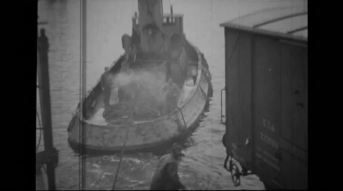 Military men working around a large ship Stock Footage