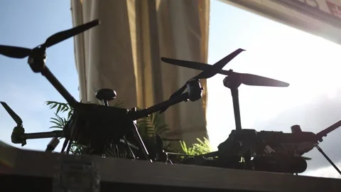 Military multirotor drones displayed in backlight for reconnaissance and surveil Stock Footage 346451573