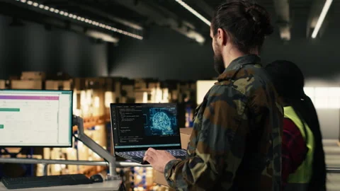 Military officer using AI-powered tools in warehouse at military base Stock Footage 330441796