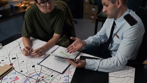 Military Officers Analyzing Tactical Map with Digital Tablet Stock Footage 343736107