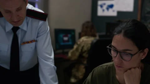 Military Officers Analyzing Tactical Map in Command Center Stock Footage 343743170