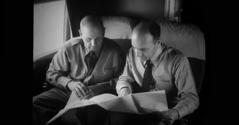 Military officers looking at map and planning in aircraft Stock Footage
