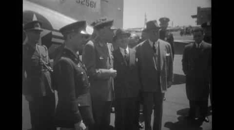 Military officers standing and talking in front of aeroplane Stock Footage