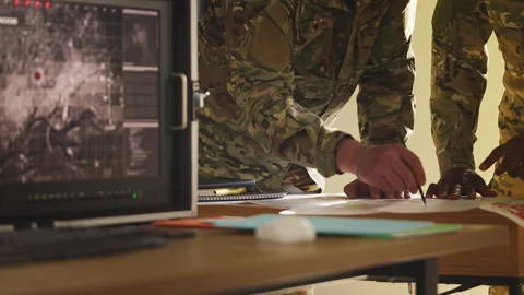Military officers using detailed map and surveillance data, discussing strategy Stock Footage 335539600