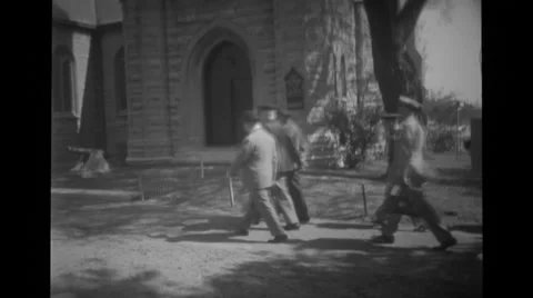 Military officers walking by building Stock Footage