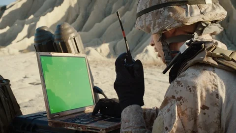 Military Operation in the Desert: Soldier Works on Green Choma Key Screen Laptop Stock Footage