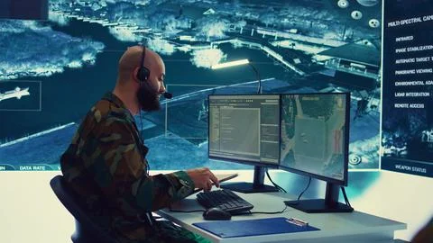 Military operator transmitting gps coordinates of hostile ships to national Stock Photos
