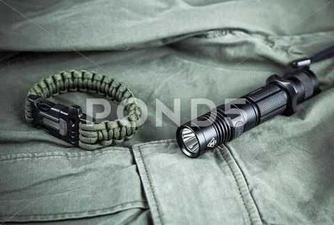 Military paracord bracelet and tactical torch Stock Photos
