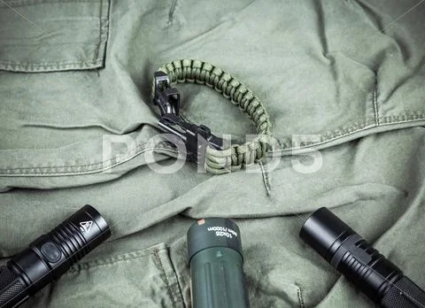 Military paracord bracelet, tactical torch and spy-glass Stock Photos