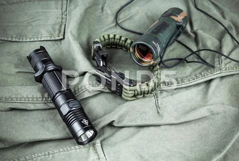 Military paracord bracelet, tactical torch and spy-glass Stock Photos