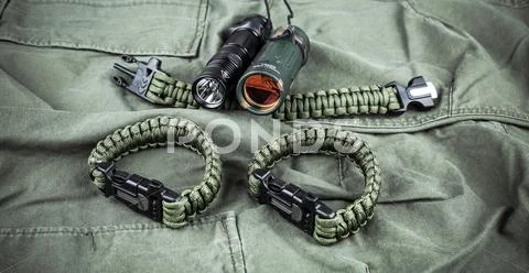 Military paracord bracelet, tactical torch and spy-glass Stock Photos