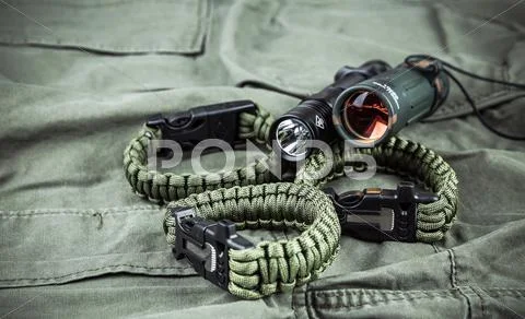 Military paracord bracelet, tactical torch and spy-glass Stock Photos