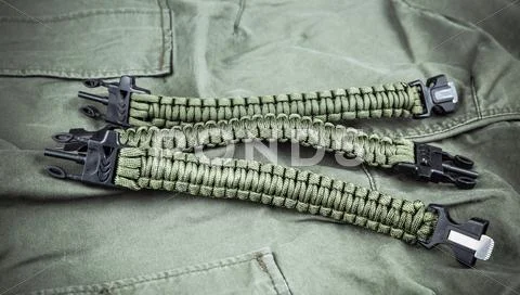 Military paracord bracelets on army-green fabric Stock Photos