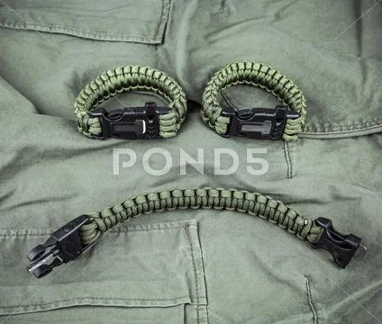 Military paracord bracelets on army-green fabric Stock Photos