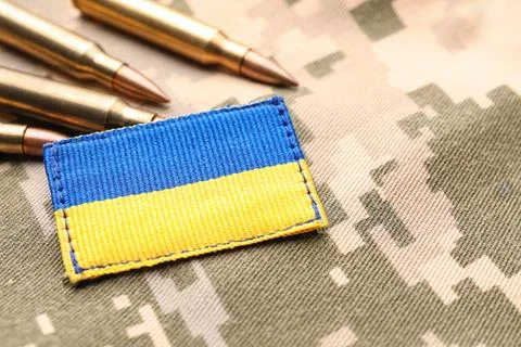 Military patch and bullets on pixel Ukrainian camouflage, closeup Fotos de archivo