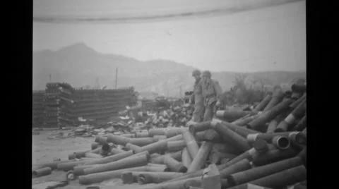 Military photographers walking across heaps of bullets Stock Footage