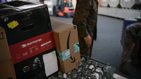 Military postal workers loading parcels onto conveyor Stock Footage 122210781